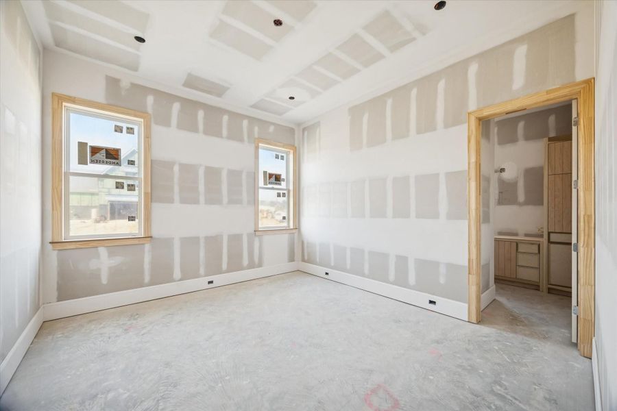 This first-floor secondary bedroom offers a spacious layout with tall ceilings and generous natural light, creating a warm, comfortable feel. Its location on the main level makes it ideal for guests, multigenerational living, or a flexible use space. Once finished, the room will blend convenience with the same elevated design found throughout the home.