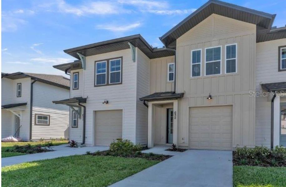 Front exterior of a new home in , Davenport, FL, highlighting curb appeal (Image 1).
