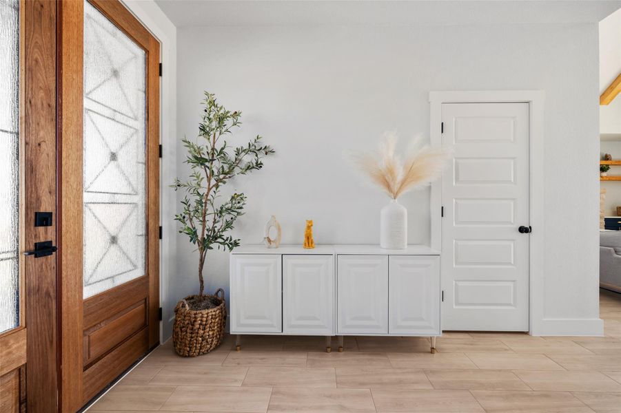 Foyer featuring wood tiled floors and baseboards