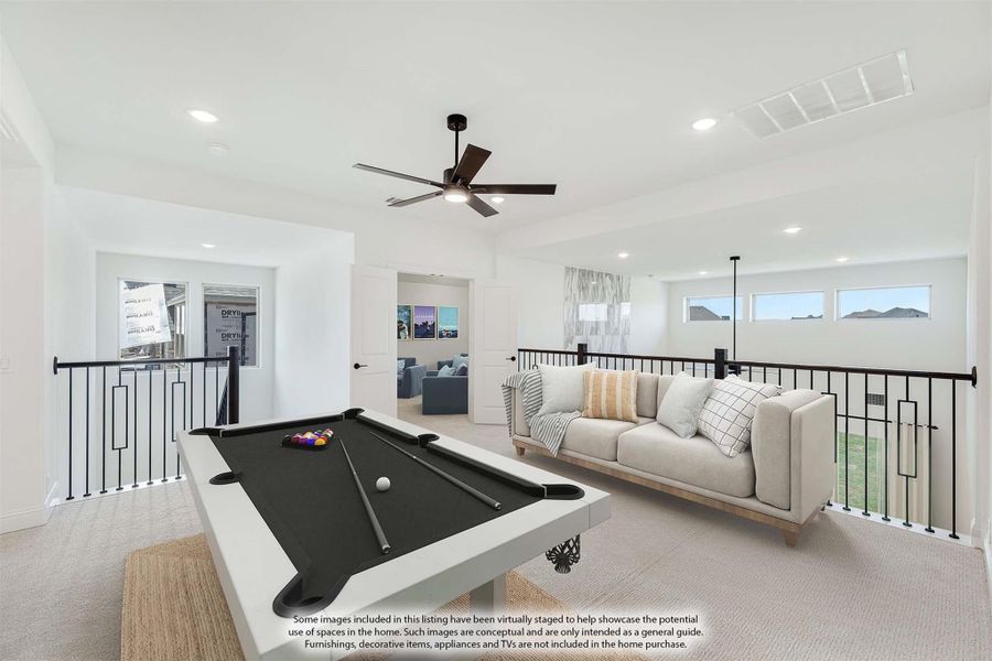 Upstairs game room with pool table, sofa, ceiling fan, and black metal railing overlooking lower level