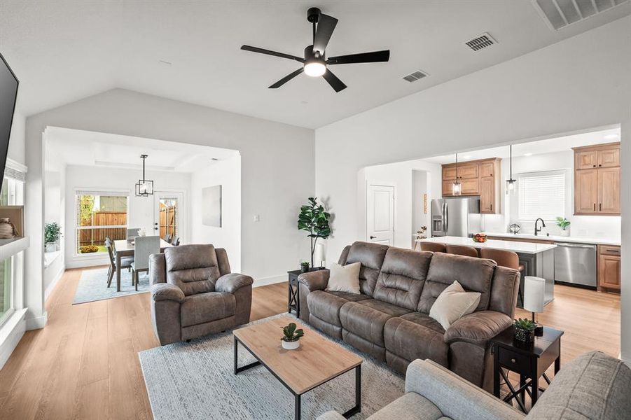 Living room featuring light wood finished floors and ceiling fan Living room featuring light wood finished floors and ceiling fan