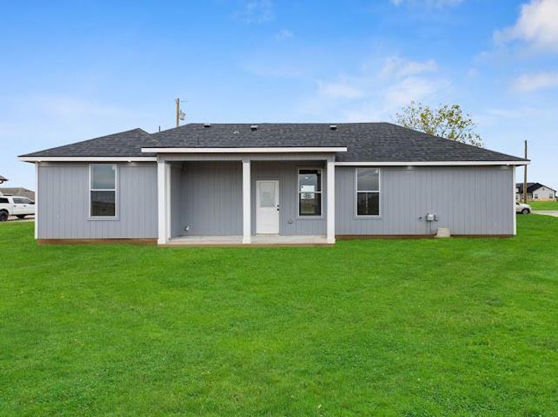 Rear view of property with roof with shingles, a patio, and a yard Rear view of property with roof with shingles, a patio, and a yard
