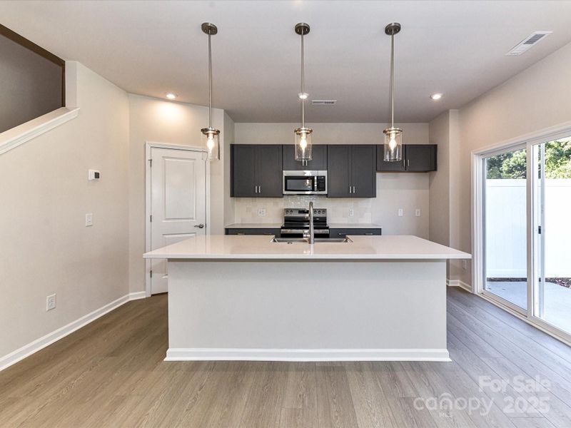 Dark Cabinetry and White Quartz Countertops Pair Perfectly Together.