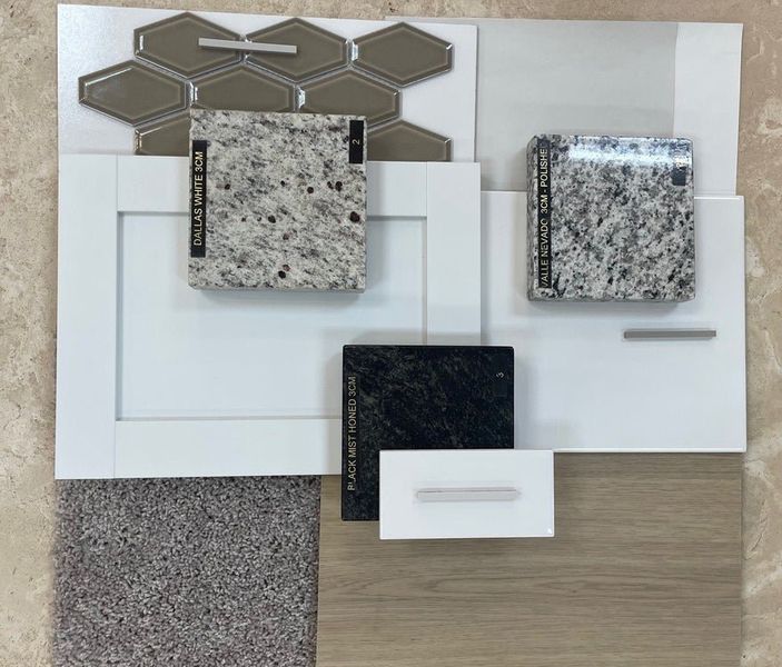 Home design material board with granite countertop samples, white cabinet doors, tile, carpet, and wood flooring swatches Home design material board with granite countertop samples, white cabinet doors, tile, carpet, and wood flooring swatches