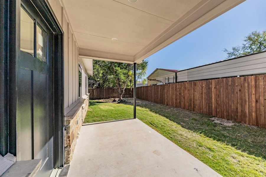 Fenced backyard with a patio area
