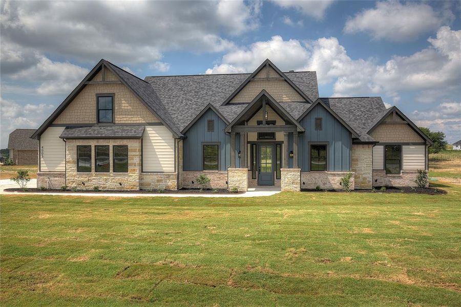 Craftsman inspired home with a front lawn