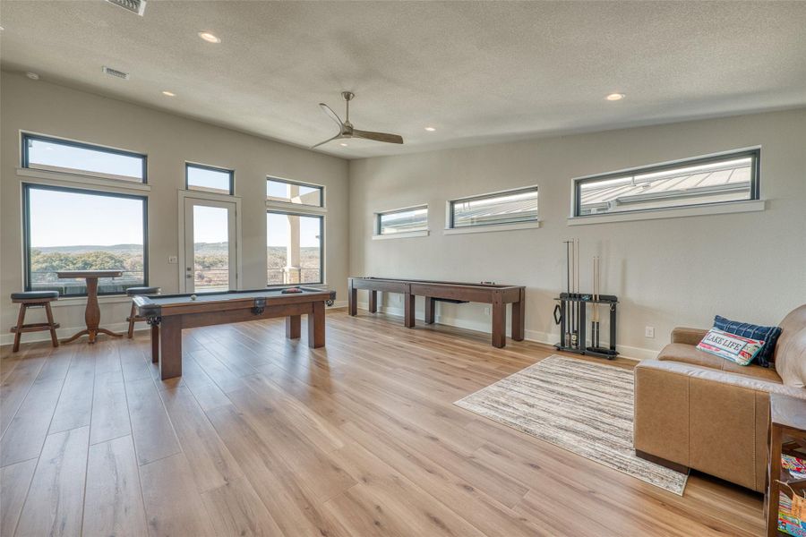 Pool, shuffle board, and TV for watching sports, all overlooking the water.