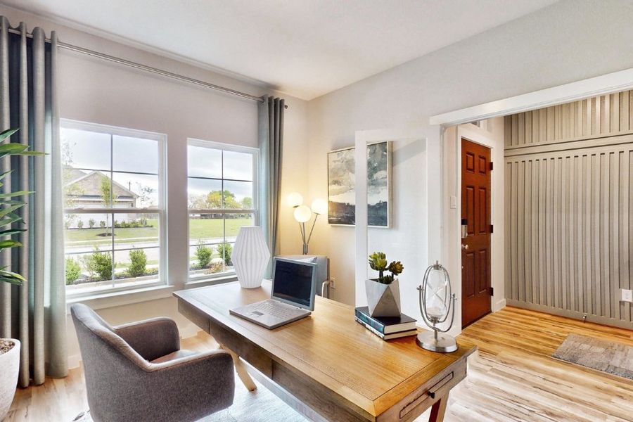 A living room with a laptop on a table.