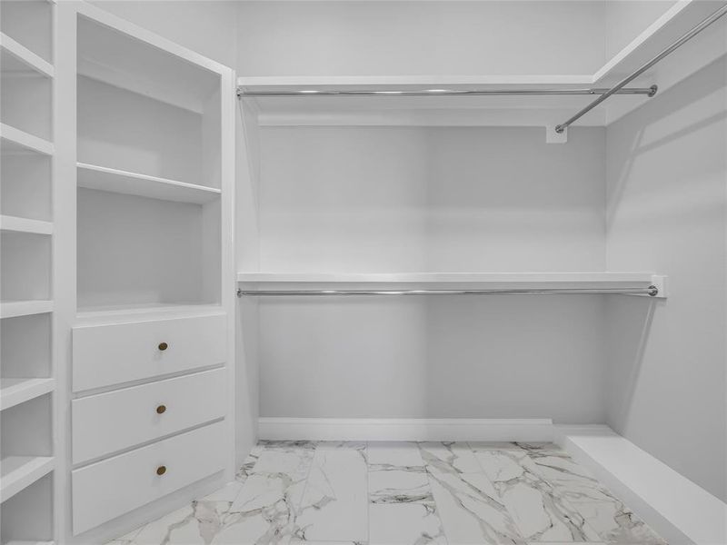 Large primary walk-in closet Large primary walk-in closet