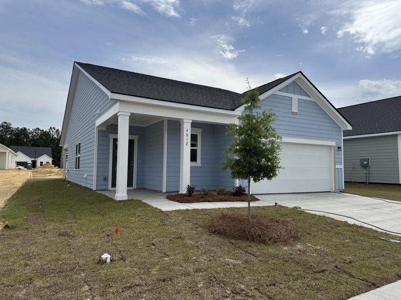 Front exterior of a new home in Tea Farm, Ravenel, SC, highlighting curb appeal (Image 17). Front exterior of a new home in Tea Farm, Ravenel, SC, highlighting curb appeal (Image 17).