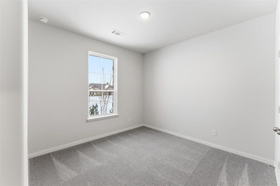 Carpeted spare room featuring baseboards Carpeted spare room featuring baseboards