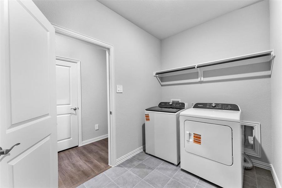 Laundry room featuring washer and clothes dryer and light tile patterned flooring INCLUDED Laundry room featuring washer and clothes dryer and light tile patterned flooring INCLUDED