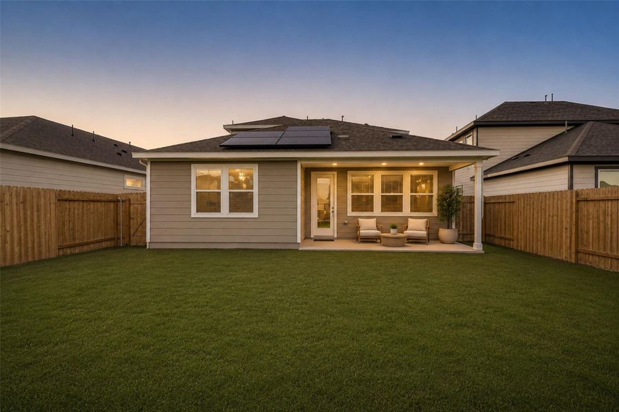 Fully fenced backyard with covered patio and open green space, offering room for outdoor seating, play, or future customization.Virtually staged furnishings shown for visual purposes only.