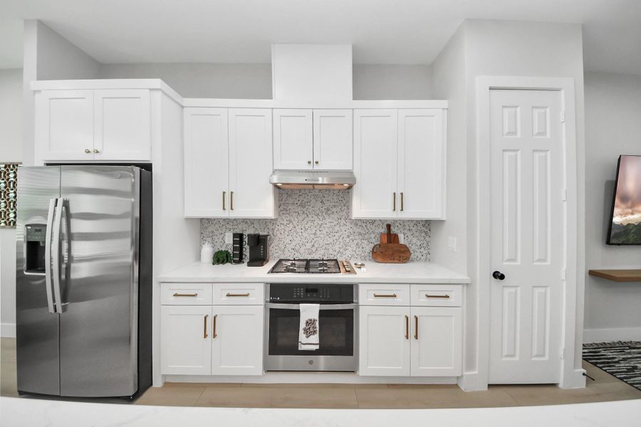 Sleek kitchen with built-in stainless-steel appliances Sleek kitchen with built-in stainless-steel appliances