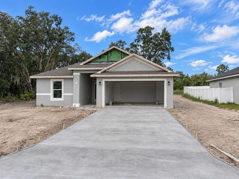 Front exterior of a new home in Poinciana - Polk County, Poinciana, FL, highlighting curb appeal (Image 2). Front exterior of a new home in Poinciana - Polk County, Poinciana, FL, highlighting curb appeal (Image 2).