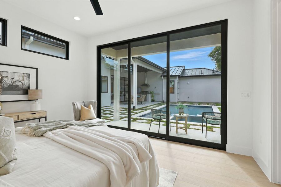 Bedroom featuring wood finished floors, a ceiling fan, recessed lighting, and access to outside Bedroom featuring wood finished floors, a ceiling fan, recessed lighting, and access to outside