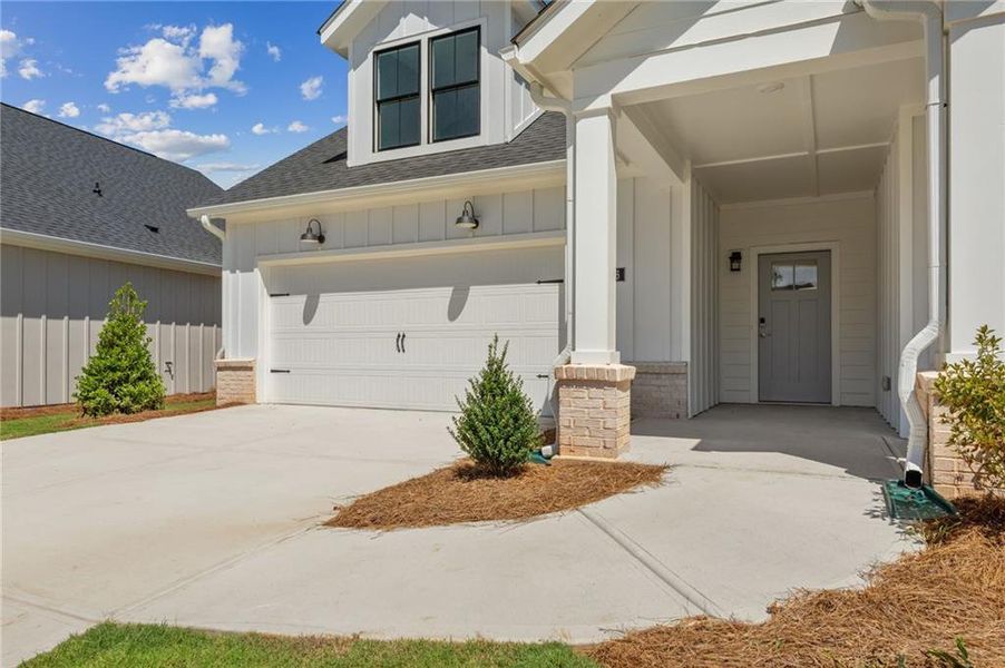 Front exterior of a new home in The Courtyards at Redbud Lane, Canton, GA, highlighting curb appeal (Image 2).