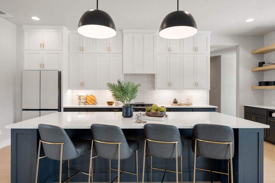 Sleek modern cabinetry and a generous center island define this refined culinary space.