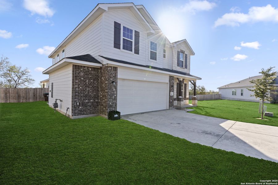 Front exterior of a new home in Hickory Ridge, Elmendorf, TX, highlighting curb appeal (Image 2).
