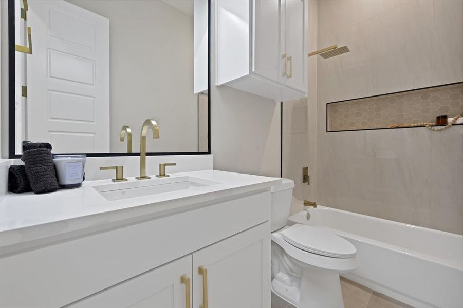 Bathroom with vanity, toilet, shower / bathtub combination, and tile patterned floors