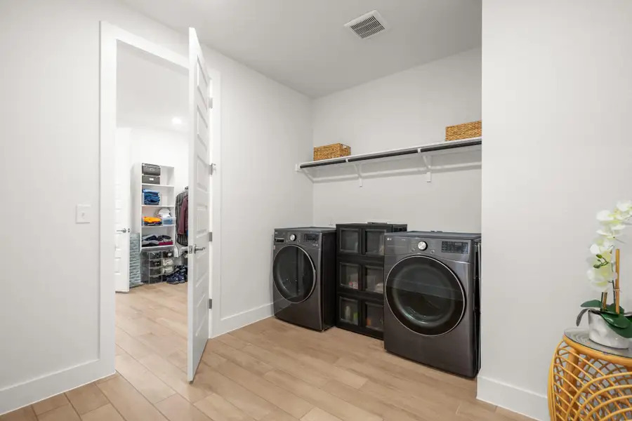 Laundry room connects with the primary bedroom bathroom
