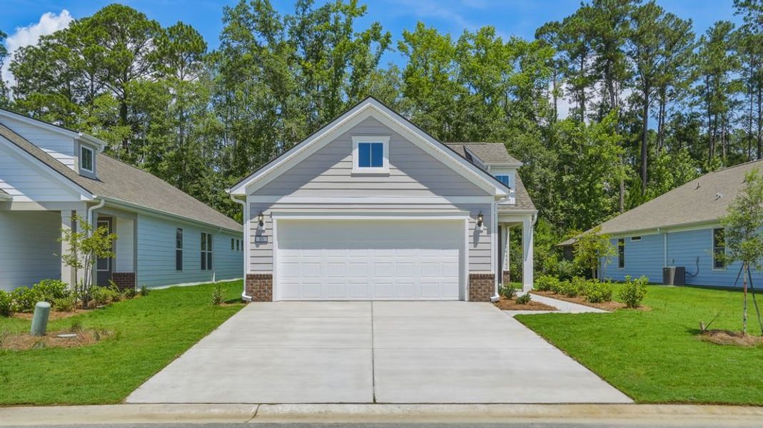 Front exterior of a new home in Sun City Hilton Head, Bluffton, SC, highlighting curb appeal (Image 25). Front exterior of a new home in Sun City Hilton Head, Bluffton, SC, highlighting curb appeal (Image 25).