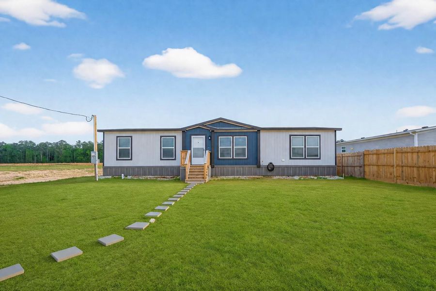 Front elevation of the property showcasing a spacious lot and clean exterior design. Grass in images has been AI generated for visualization purposes. Front elevation of the property showcasing a spacious lot and clean exterior design. Grass in images has been AI generated for visualization purposes.