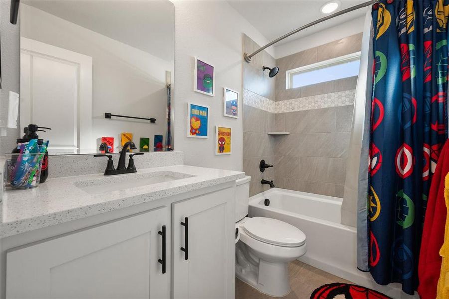 Bathroom featuring shower / bath combination with curtain and vanity