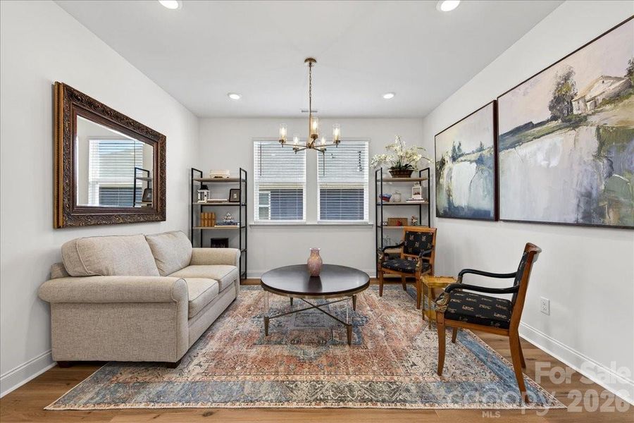 Dining/sitting room with 2 large windows and an updated champagne bronze finish light fixture.