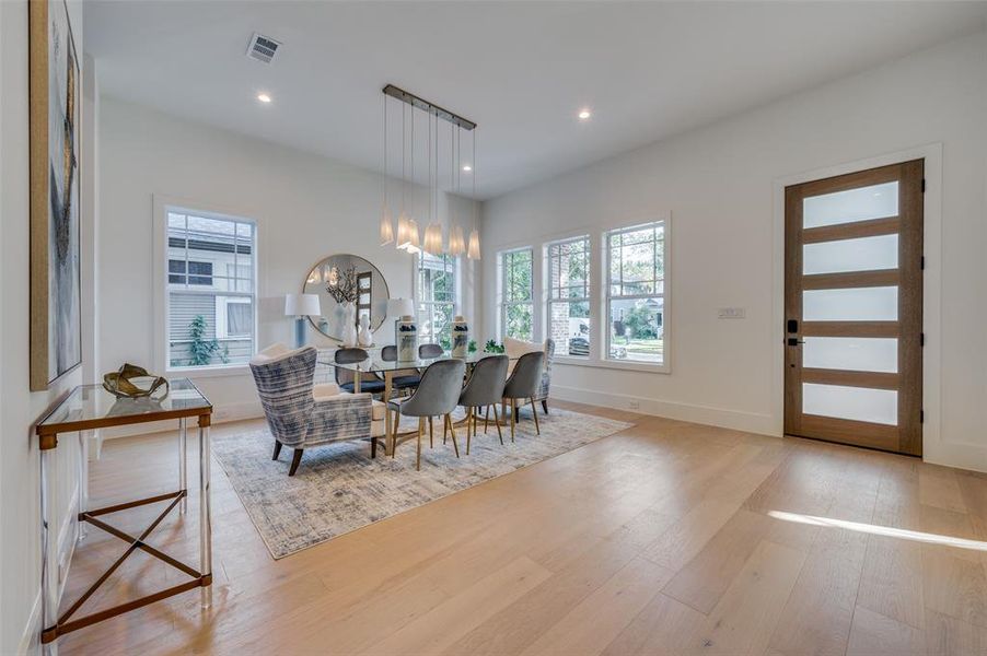 Dining area featuring a chandelier and light hardwood / wood-style floors