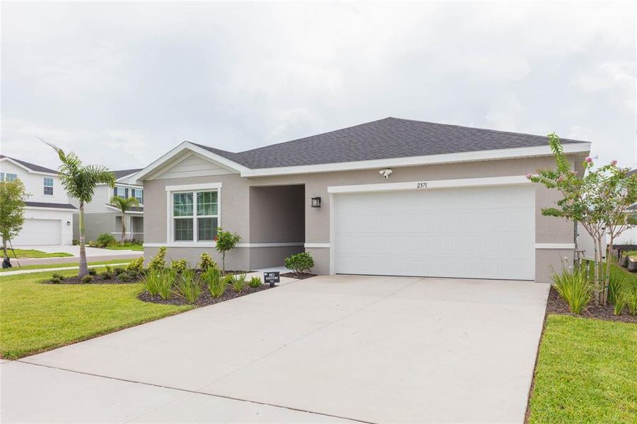 Front exterior of a new home in Cypress Ridge Ranch, Wimauma, FL, highlighting curb appeal (Image 1). Front exterior of a new home in Cypress Ridge Ranch, Wimauma, FL, highlighting curb appeal (Image 1).