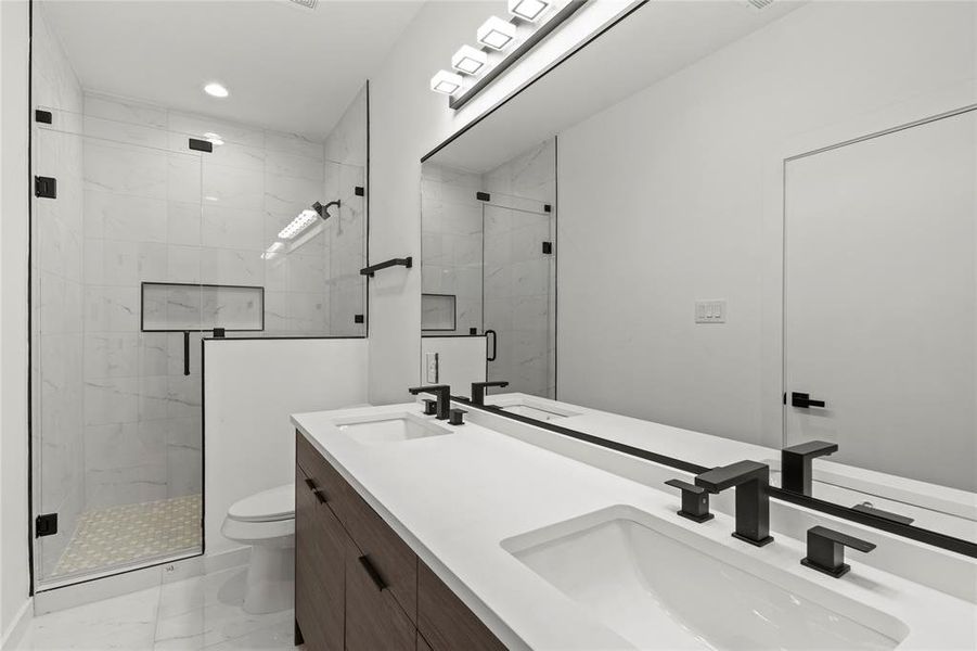 Bathroom featuring vanity, toilet, and walk in shower