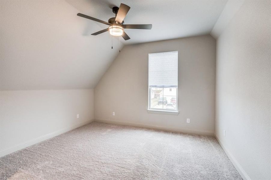 Bonus room featuring carpet, ceiling fan, and lofted ceiling