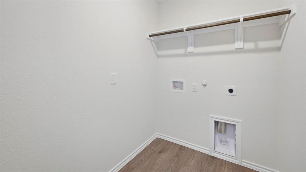 Laundry room with hookup for a gas dryer, dark wood-style flooring, washer hookup, and hookup for an electric dryer Laundry room with hookup for a gas dryer, dark wood-style flooring, washer hookup, and hookup for an electric dryer