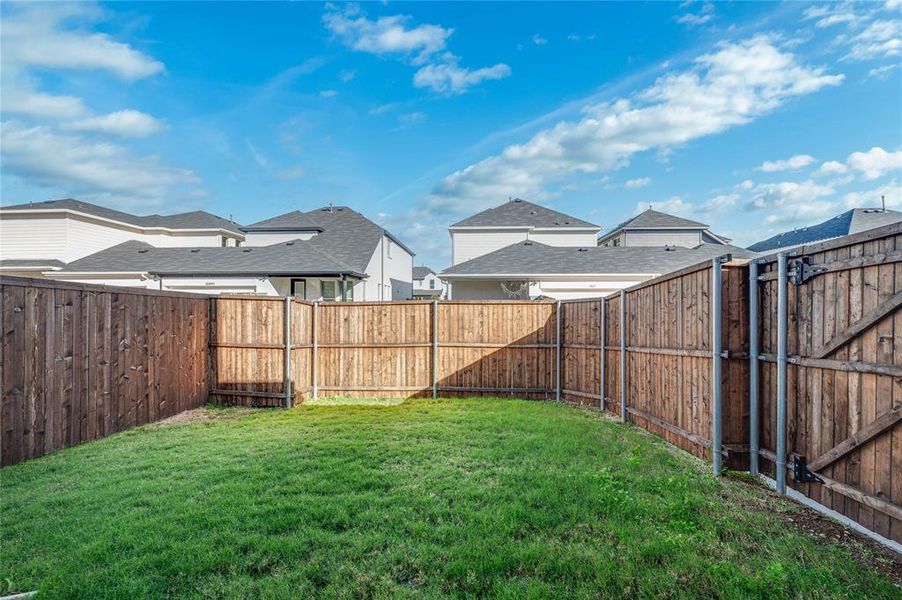 Private fenced yard surrounded by nice wood fence.