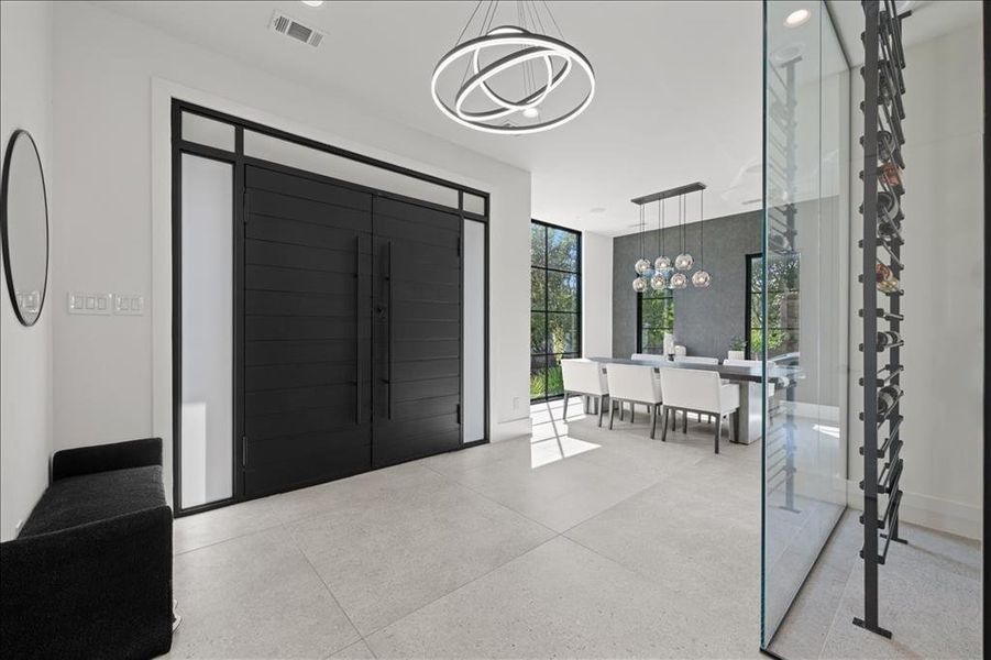 Entrance foyer featuring a chandelier and speckle patterned floor