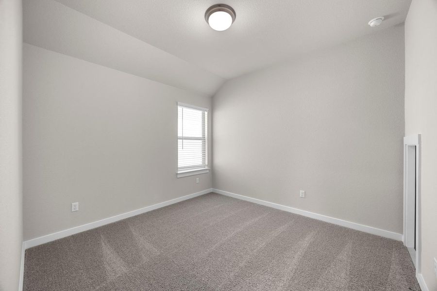 A well-lit bedroom features plush carpeting and a window with blinds, creating a comfortable personal space. A well-lit bedroom features plush carpeting and a window with blinds, creating a comfortable personal space.