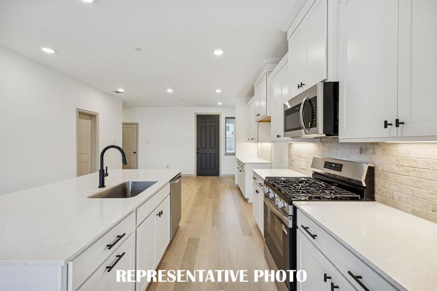 Beautiful cabinetry, gorgeous countertops and designer backsplash effortlessly pair with contemporary stainless steel to create a timeless kitchen!  REPRESENTATIVE PHOTO