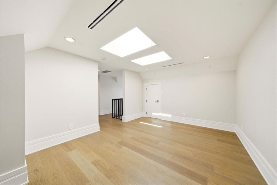 Multi functional game room with skylights, hardwood flooring, and endless possibilities for a media room, office, or playroom. Multi functional game room with skylights, hardwood flooring, and endless possibilities for a media room, office, or playroom.