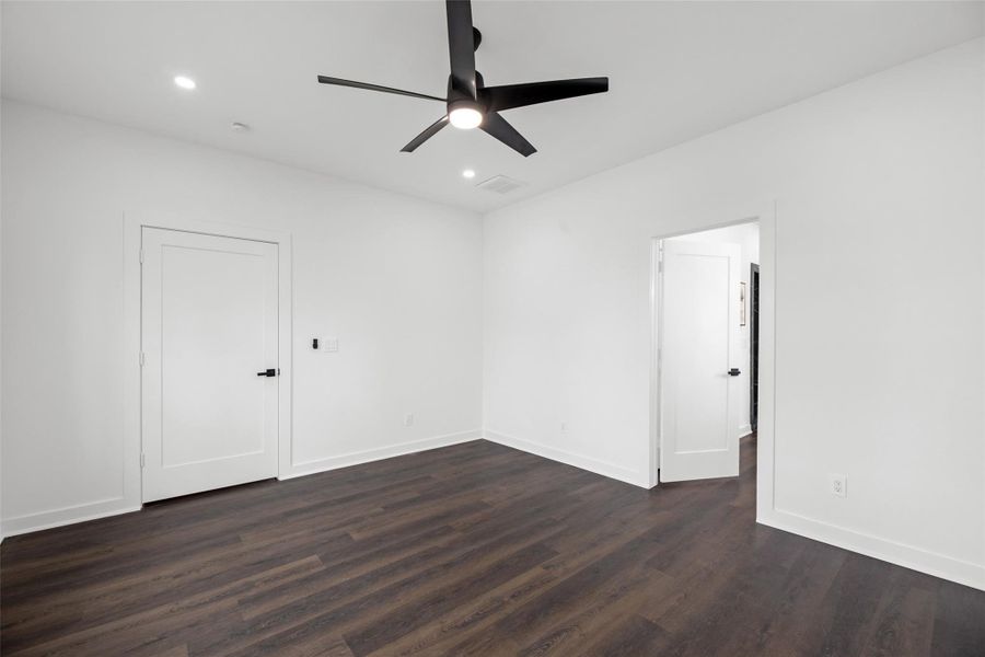 Well-lit room with recessed lighting and has two doors, offering potential for versatile use.