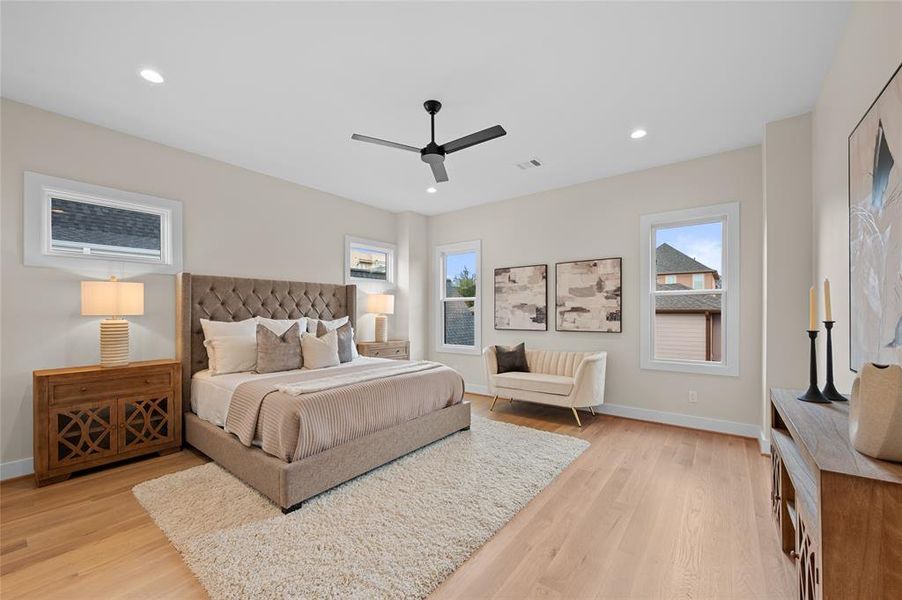 Spacious primary bedroom with white oak hardwood floors