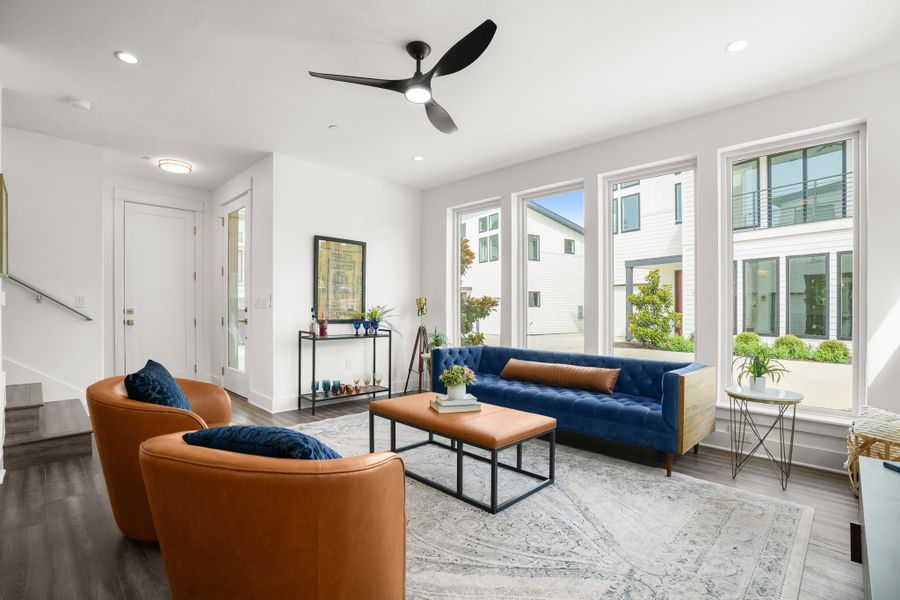 Bright windows frame neighborhood views in this inviting living space. Bright windows frame neighborhood views in this inviting living space.