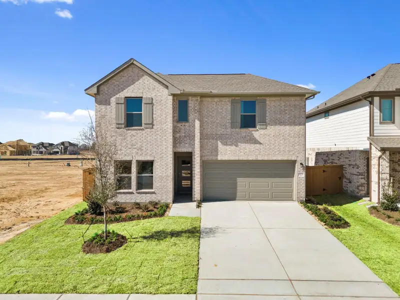 Front exterior of a new home in Cypress Green, Hockley, TX, highlighting curb appeal (Image 1). Front exterior of a new home in Cypress Green, Hockley, TX, highlighting curb appeal (Image 1).