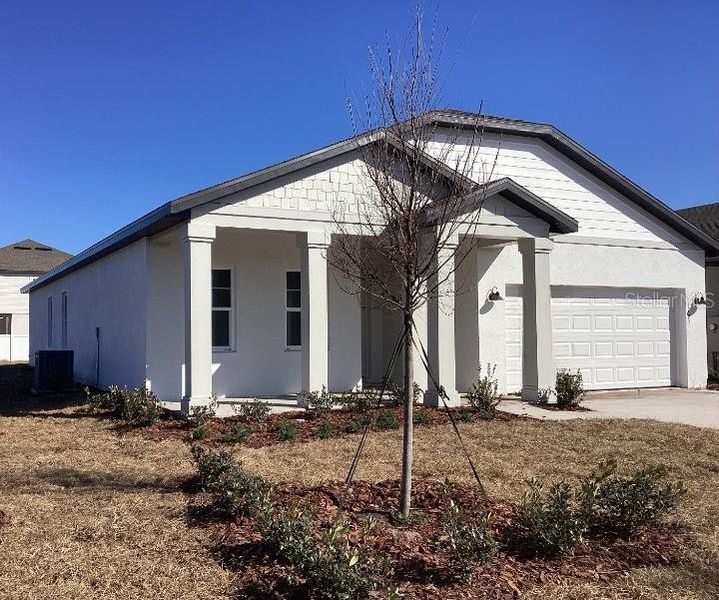 Front exterior of a new home in Sunbrooke, St. Cloud, FL, highlighting curb appeal (Image 18). Front exterior of a new home in Sunbrooke, St. Cloud, FL, highlighting curb appeal (Image 18).