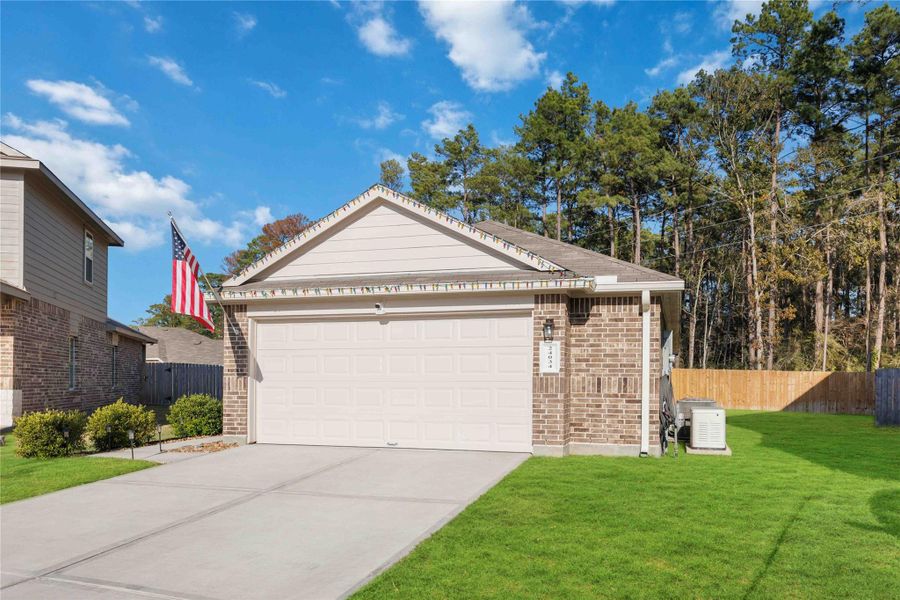 Additional exterior view highlighting the oversized 2-car garage and generous side yard. The home backs to a tree-lined area with no rear neighbors, enhancing privacy and outdoor enjoyment. Additional exterior view highlighting the oversized 2-car garage and generous side yard. The home backs to a tree-lined area with no rear neighbors, enhancing privacy and outdoor enjoyment.