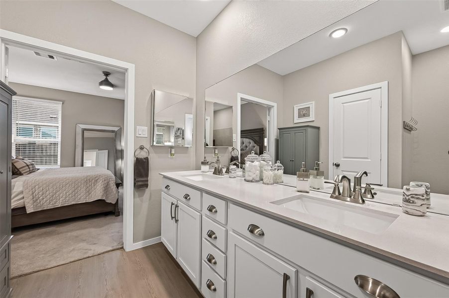 Bright en-suite primary bathroom featuring a spacious dual-sink vanity with generous counter space, abundant cabinetry, modern fixtures, and an expansive wall mirror. Neutral finishes and recessed lighting create a clean, polished feel with convenient access to the primary bedroom. Bright en-suite primary bathroom featuring a spacious dual-sink vanity with generous counter space, abundant cabinetry, modern fixtures, and an expansive wall mirror. Neutral finishes and recessed lighting create a clean, polished feel with convenient access to the primary bedroom.