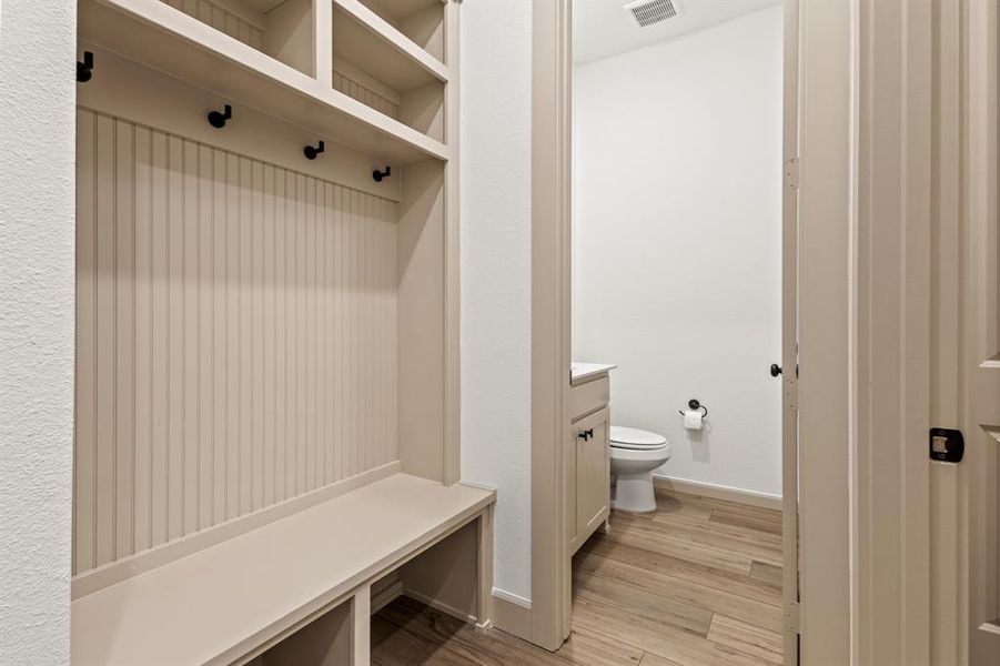 Mudroom featuring light wood-style floors and baseboards