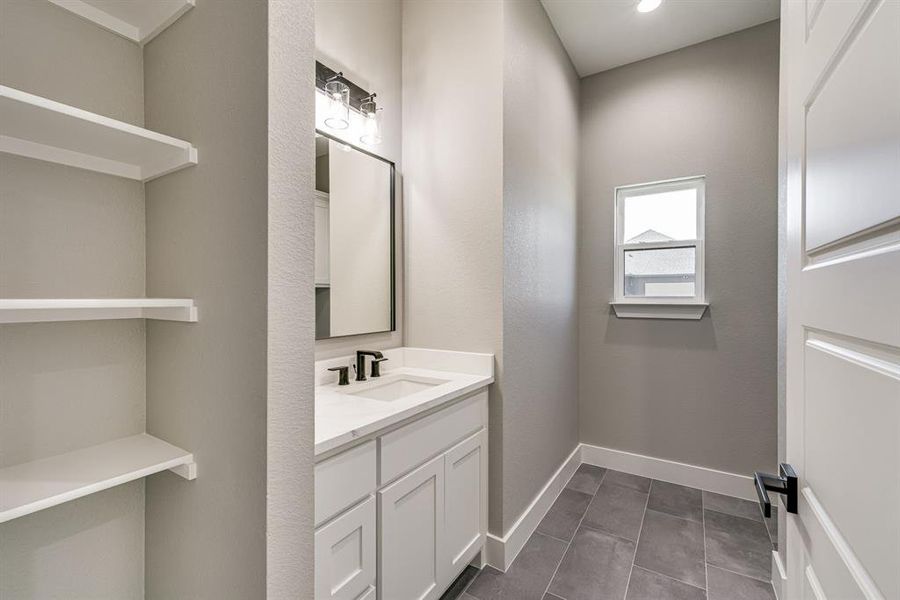 Bathroom featuring vanity and tile patterned floors