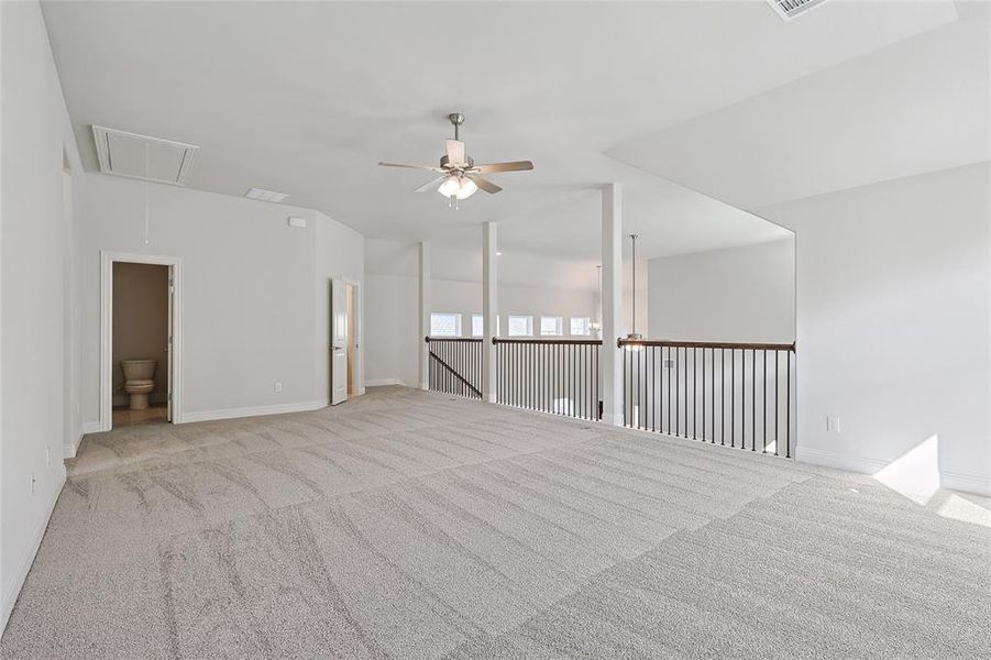 Empty room featuring carpet flooring and a ceiling fan Empty room featuring carpet flooring and a ceiling fan