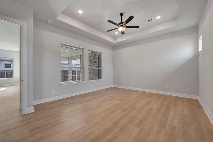Empty room featuring ceiling fan, light wood-type flooring, and recessed lighting